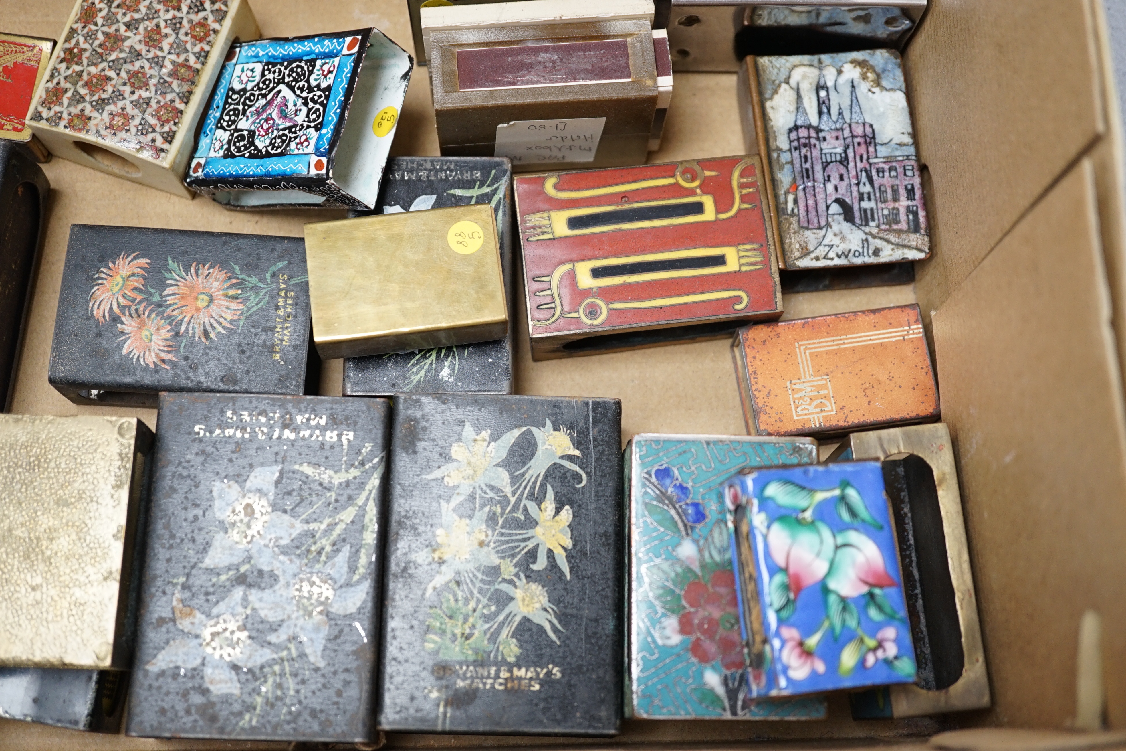 A collection of advertising and other enamelled metal match box holders